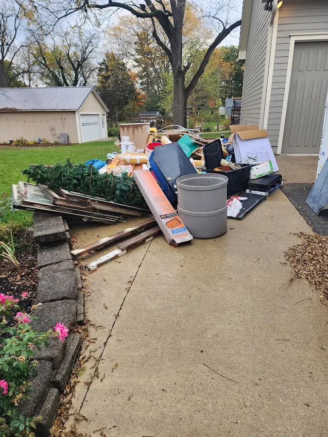 Dumpster being loaded with debris for Estate Cleanout Dumpster Rental in Charleston